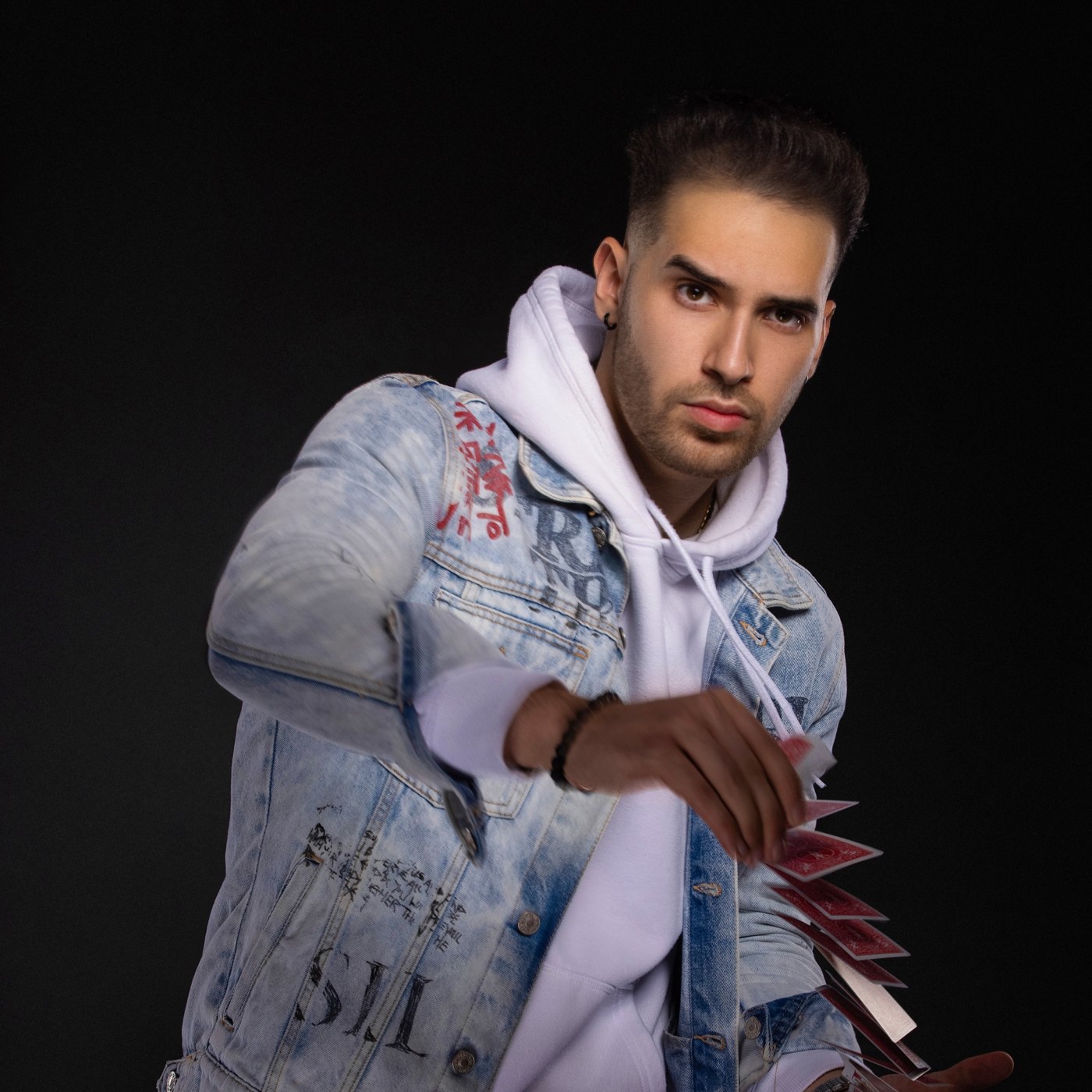 TJ Salta holding a fan of playing cards